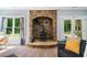 Living room with stone fireplace and backyard views at 1825 Epperson Rd, Canton, GA 30115