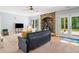 Living room boasts a stone fireplace, and French door access to the outdoors at 1825 Epperson Rd, Canton, GA 30115