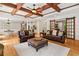 Spacious living room with wood beams, hardwood floors, and easy access to dining and kitchen areas at 1825 Epperson Rd, Canton, GA 30115