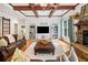 Open living room with fireplace and wood ceiling beams at 1825 Epperson Rd, Canton, GA 30115