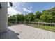 Spacious wooden back deck with wooden railing overlooking the green backyard at 2180 Oakpointe Ct, Buford, GA 30519
