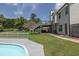 The backyard features a deck, pool, and hot tub, set amongst mature trees and on a sunny day at 2180 Oakpointe Ct, Buford, GA 30519