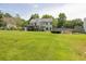 This large backyard features a garden, pool, and deck, surrounded by lush greenery and mature trees at 2180 Oakpointe Ct, Buford, GA 30519