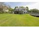 The sprawling backyard features a deck, pool, hot tub, and shed amongst mature trees at 2180 Oakpointe Ct, Buford, GA 30519