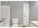 Cozy bathroom featuring a tub-shower combination, white toilet, and simple vanity at 2180 Oakpointe Ct, Buford, GA 30519