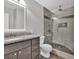 Modern bathroom showcasing a glass shower, granite vanity, and updated fixtures at 2180 Oakpointe Ct, Buford, GA 30519