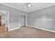 Bedroom with neutral walls, plush carpeting, ceiling fan, and closet at 2180 Oakpointe Ct, Buford, GA 30519