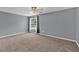 Spacious bedroom features neutral carpet, ceiling fan, and a window overlooking backyard pool at 2180 Oakpointe Ct, Buford, GA 30519