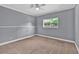 Bedroom with neutral walls, plush carpeting, ceiling fan, and a window offering natural light at 2180 Oakpointe Ct, Buford, GA 30519