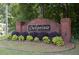 A welcoming brick sign marks the entrance to the Oakpointe community with lush landscaping at 2180 Oakpointe Ct, Buford, GA 30519