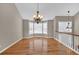 Bright dining area with bay window, lovely lighting fixture, hardwood floors and staircase to upper level at 2180 Oakpointe Ct, Buford, GA 30519