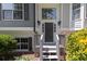 Close-up view of the welcoming front door with sidelights and decorative lighting fixtures at 2180 Oakpointe Ct, Buford, GA 30519