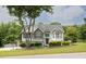 Beautiful home with green lawn, shrubbery, brick accents and a mix of vinyl and brick exterior at 2180 Oakpointe Ct, Buford, GA 30519