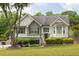 Charming two-story home with manicured lawn, lovely shrubbery, and a mix of vinyl and brick exterior at 2180 Oakpointe Ct, Buford, GA 30519