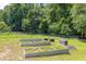 A backyard garden with raised metal planters is surrounded by a chain link fence at 2180 Oakpointe Ct, Buford, GA 30519