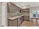 Kitchenette with custom cabinetry, stone countertops, stainless appliances and wine cooler at 2180 Oakpointe Ct, Buford, GA 30519