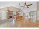 Open kitchen features stainless appliances, granite countertops, and a large island overlooking hardwood floors at 2180 Oakpointe Ct, Buford, GA 30519