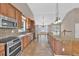 Kitchen with stainless appliances, granite counters, island, and seamless flow into the dining area at 2180 Oakpointe Ct, Buford, GA 30519