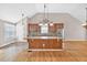 Kitchen with large island, granite countertops, stainless steel appliances, and a vaulted ceiling at 2180 Oakpointe Ct, Buford, GA 30519
