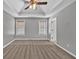 Neutral painted and carpeted main bedroom features a trey ceiling and ceiling fan at 2180 Oakpointe Ct, Buford, GA 30519