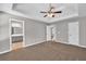 The main bedroom features neutral carpet, paint, and a trey ceiling leading to a full ensuite bath at 2180 Oakpointe Ct, Buford, GA 30519