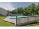 Fenced yard with in-ground pool, wooden deck, and backyard at 2180 Oakpointe Ct, Buford, GA 30519