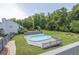 Aerial view of fenced in yard with pool, wooden deck, and garden plots at 2180 Oakpointe Ct, Buford, GA 30519