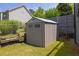 A backyard shed is surrounded by a chain link fence and has good access at 2180 Oakpointe Ct, Buford, GA 30519