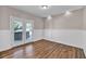 Sunroom featuring wood look floors, white wainscoting, and french doors to the backyard at 2180 Oakpointe Ct, Buford, GA 30519