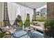 Relaxing outdoor balcony seating area with a modern furniture, curtains and beautiful plants overlooking the neighborhood at 407 Pratt Se Dr # 1101, Atlanta, GA 30315