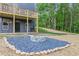New home backyard featuring a fire pit area with stone border, plus a second story deck, perfect for outdoor gatherings at 70 Wheeler Lake Path, Dallas, GA 30157