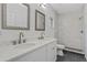 Well-lit bathroom featuring double sinks, modern finishes, and a tiled walk-in shower at 70 Wheeler Lake Path, Dallas, GA 30157
