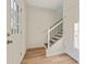 Inviting entryway with wood floors and staircase featuring white railings and black balusters at 70 Wheeler Lake Path, Dallas, GA 30157