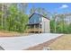 This is a two-story home with a welcoming front porch and a spacious driveway at 70 Wheeler Lake Path, Dallas, GA 30157
