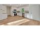 New kitchen featuring white cabinetry, stainless steel appliances, granite countertops and hardwood flooring at 70 Wheeler Lake Path, Dallas, GA 30157