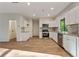 New kitchen featuring white cabinetry, stainless steel appliances, granite countertops, sink and hardwood flooring at 70 Wheeler Lake Path, Dallas, GA 30157