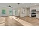 Open-concept living room flows to the kitchen with hardwood flooring and a ceiling fan above at 70 Wheeler Lake Path, Dallas, GA 30157