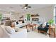 Open-concept living room flows to the kitchen with hardwood flooring and a ceiling fan above seating arrangements at 70 Wheeler Lake Path, Dallas, GA 30157