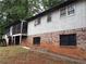 Back exterior featuring brick foundation, siding, screened porch, and surrounding landscape at 135 Golden Hills Dr, Woodstock, GA 30189