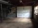 Unfinished basement with garage door at 135 Golden Hills Dr, Woodstock, GA 30189
