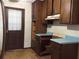Outdated kitchen cabinets and blue laminate countertops with a back door entrance at 135 Golden Hills Dr, Woodstock, GA 30189
