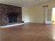Living room with fireplace, wood floors, and a door leading to another room at 135 Golden Hills Dr, Woodstock, GA 30189