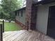 Side exterior featuring a brick chimney, siding, and wooden deck at 135 Golden Hills Dr, Woodstock, GA 30189