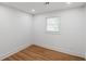 An empty bedroom featuring wood flooring, white trim, baseboards, and window at 2148 Green Forrest Dr, Decatur, GA 30032
