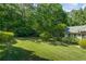 Large, well-maintained backyard featuring a lush green lawn and plenty of mature trees for privacy at 2191 Flowering Dr, Grayson, GA 30017