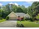 Charming home featuring a well-manicured lawn, mature trees and attached garage at 2191 Flowering Dr, Grayson, GA 30017