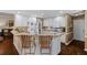 Well-lit kitchen features granite counters, white cabinets, modern appliances, and hardwood floors at 2191 Flowering Dr, Grayson, GA 30017