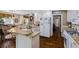 Kitchen showcases granite counters, white cabinets, hardwood floors, and breakfast bar seating at 2191 Flowering Dr, Grayson, GA 30017