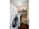 Laundry room includes front load washer and dryer, plus shelving for easy storage at 2191 Flowering Dr, Grayson, GA 30017