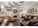 Comfortable living room with a fireplace, tray ceiling, and plush seating at 2191 Flowering Dr, Grayson, GA 30017